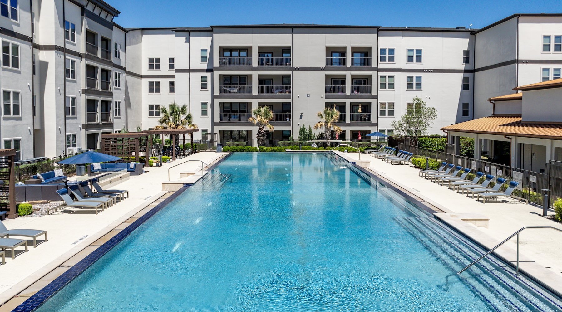resort style pool with seating in a courtyard