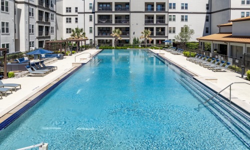 resort style pool with seating in a courtyard