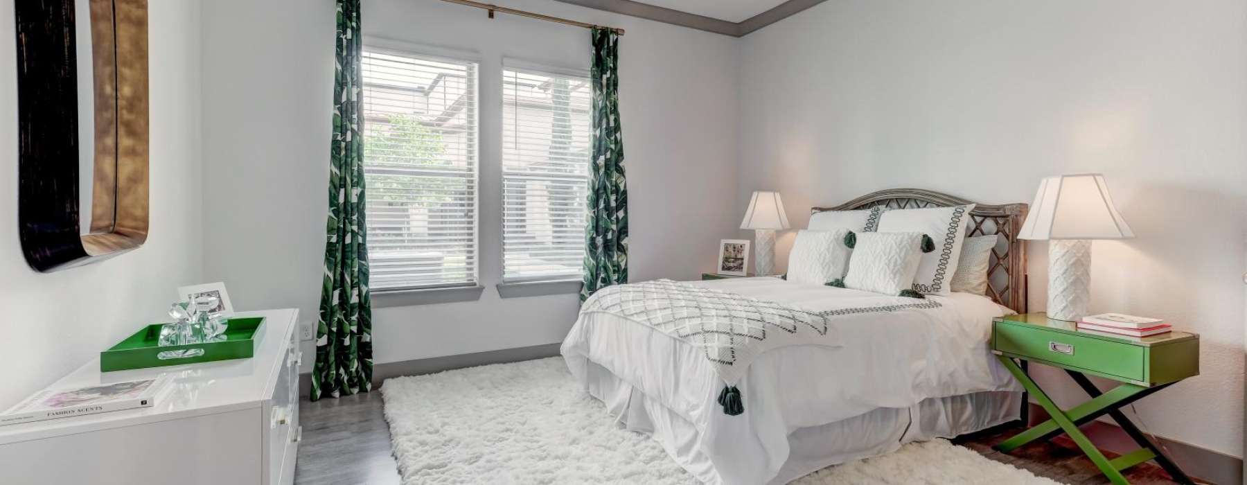 a bedroom with a bed and a mirror